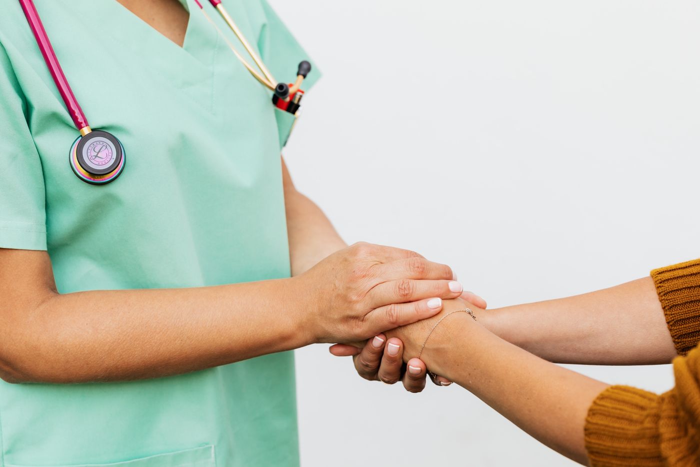 A reassuring hand held by a health professional
